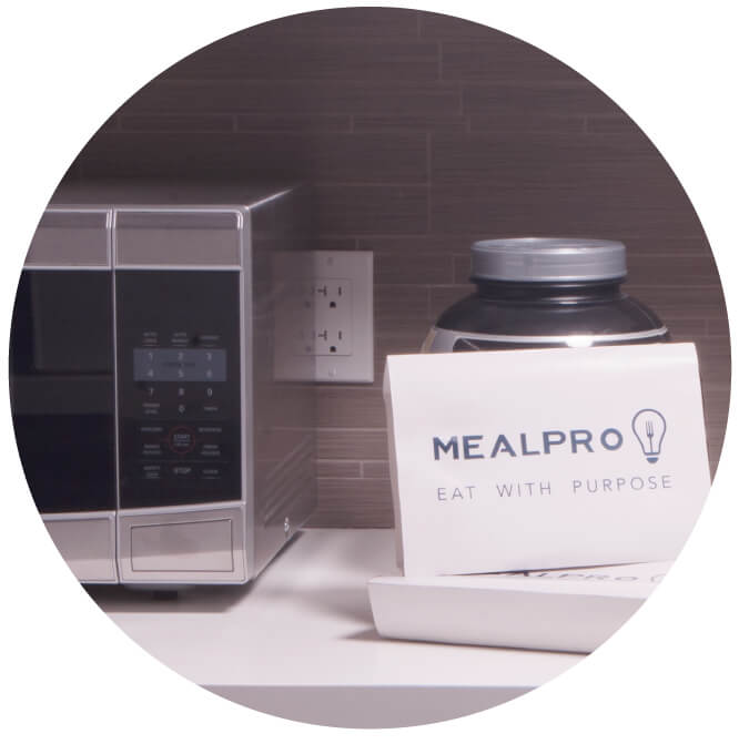 Picture of MealPro meals by a microwave. Your easy  meals are easy and just need to be heated and served. No prep or cleanup required.