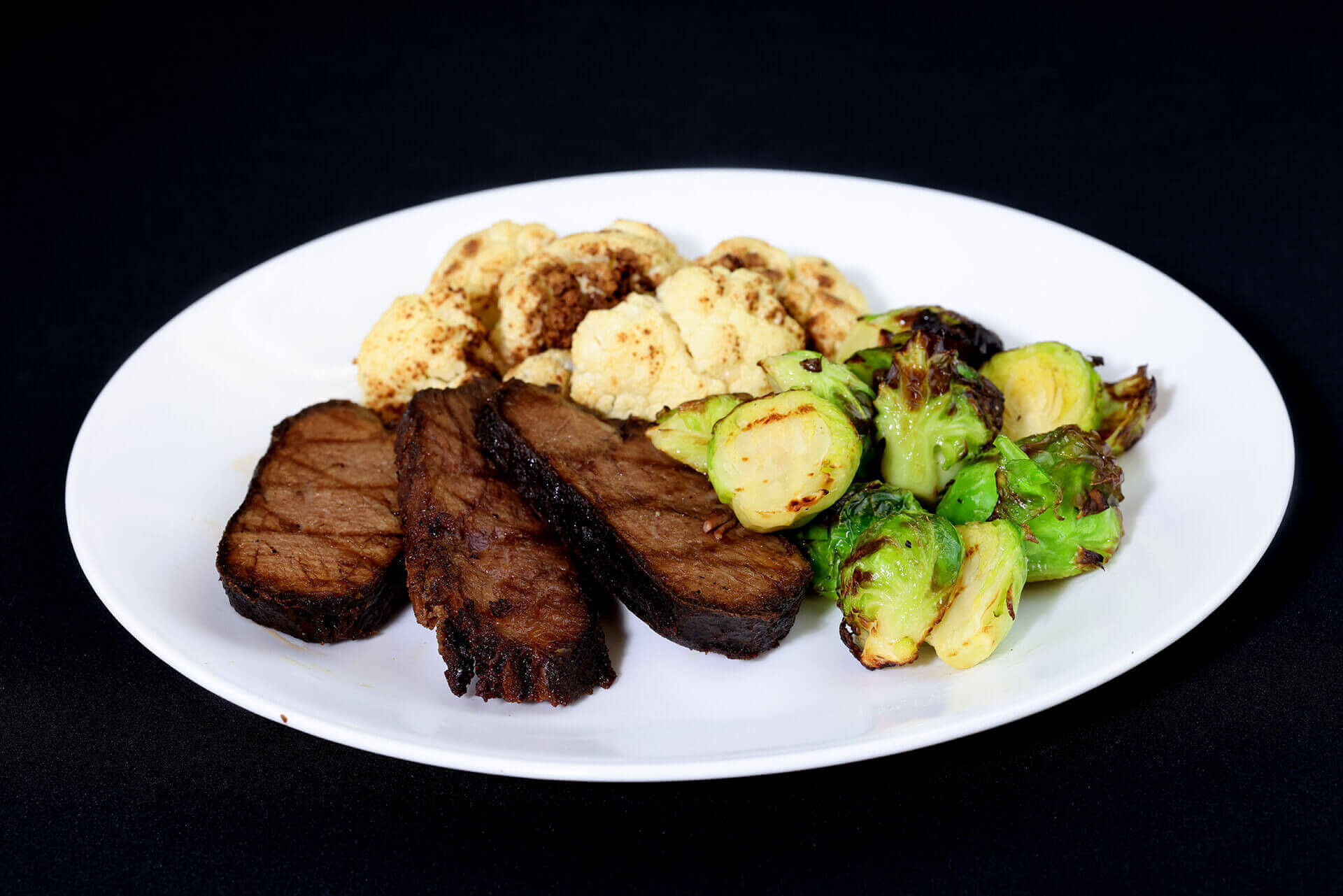 Paleo sliced steak with cauliflower and Brussels sprouts