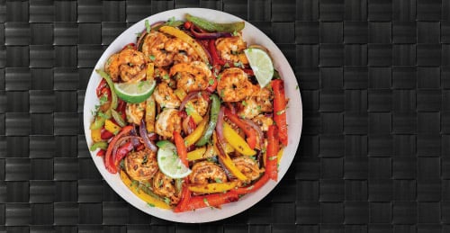 Plate of Shrimp Fajitas. Shrimp, Bell Pepper, Onion, Limes and More