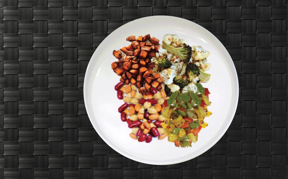 grilled meat with vegetables and grains on a white plate 