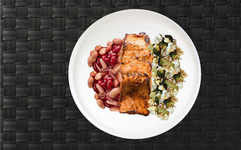 veggie and salmon meal that was prepared and is on a white plate