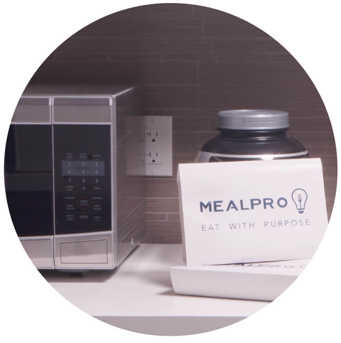 Picture of MealPro meals by a microwave. Your easy healthy meals are easy and just need to be heated and served. No prep or cleanup required.