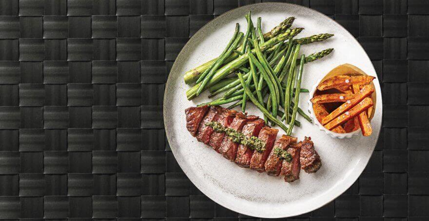 Picture of meal on a white plate that was prepped for the Bay Area delivery, ingredients are grass fed steak and sweet potato with veggies.