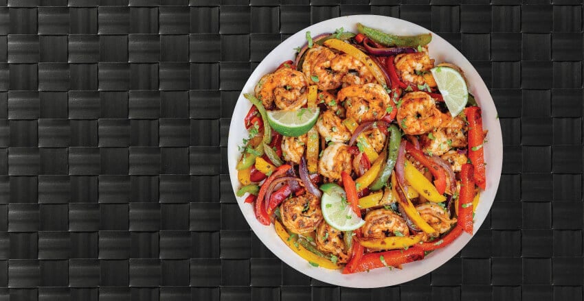 Low carb meal pictured on the plate is shrimp and bell pepper veggies. This meal is available for bay area meal delivery. 