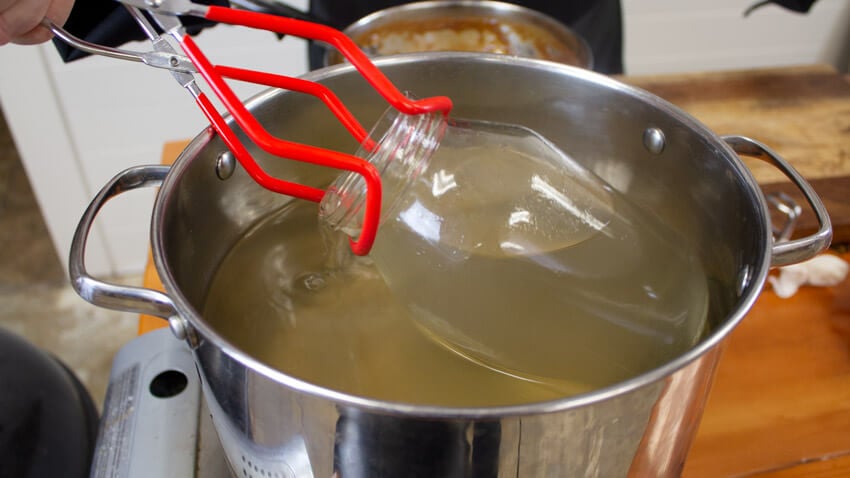place cap and jar in boiling water
