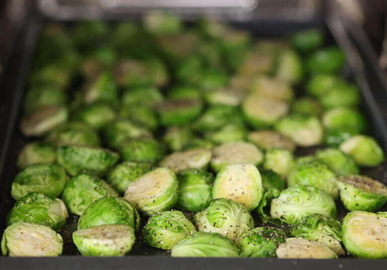 Brussels sprouts seasoned on oven tray