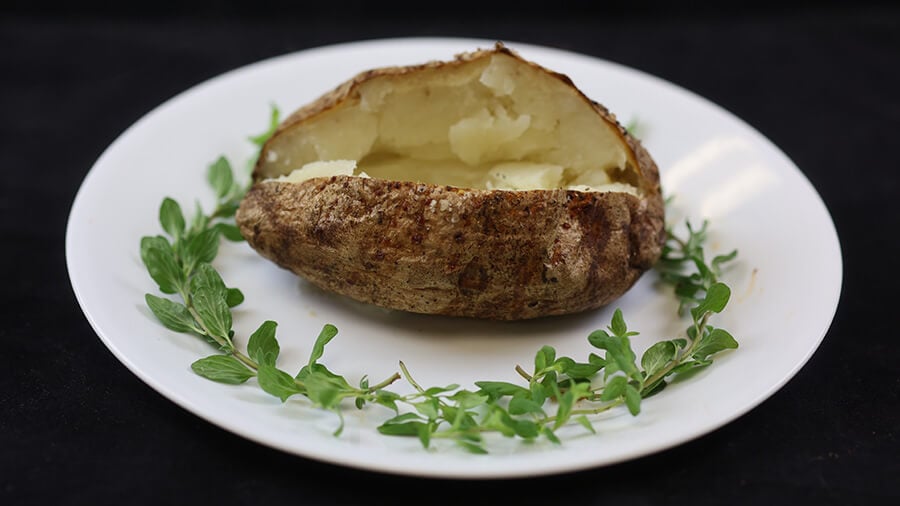 crispy baked potato plated garnished