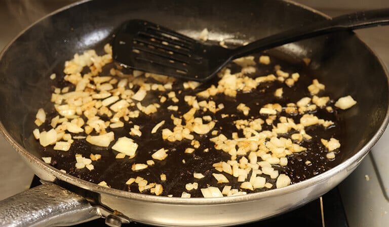 onions sautéing in pan