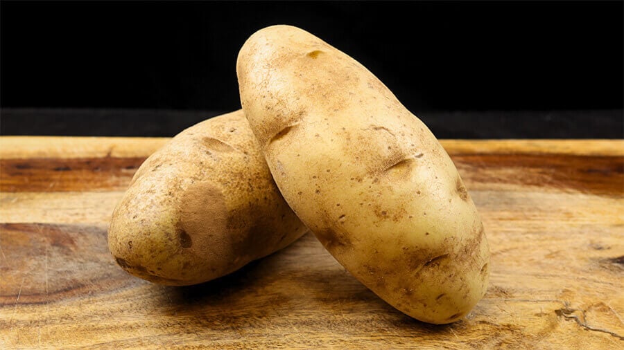 washed potatoes on cutting board