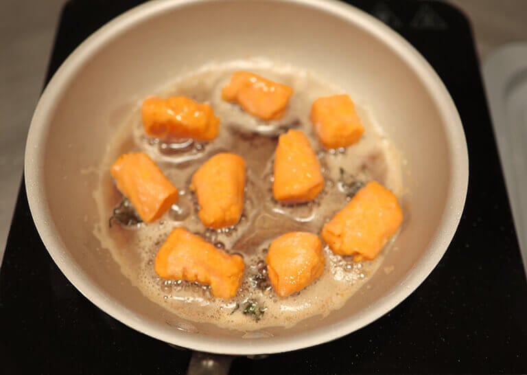 sweet potato gnocchi frying in pan