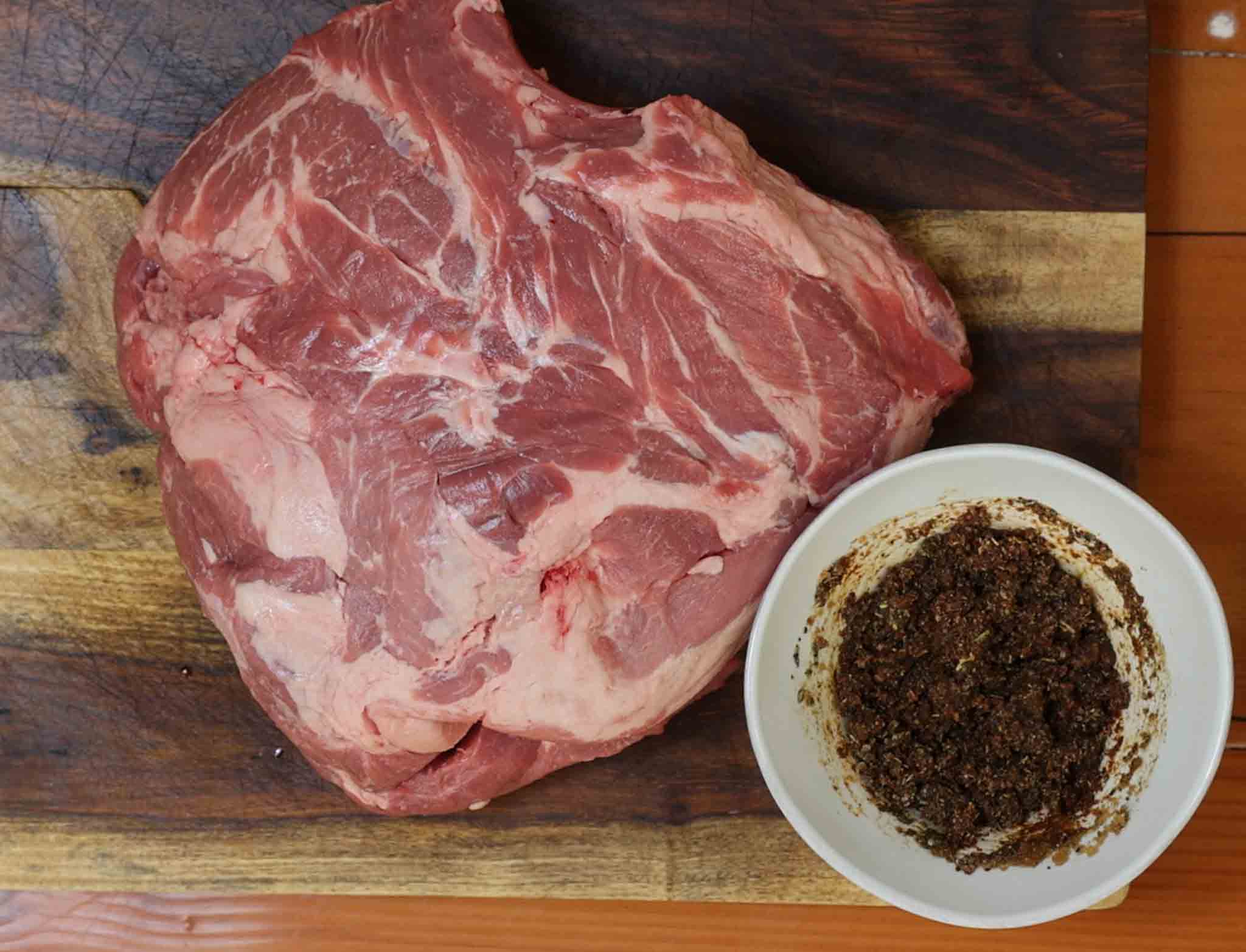 pork roast on cutting board with seasoning paste