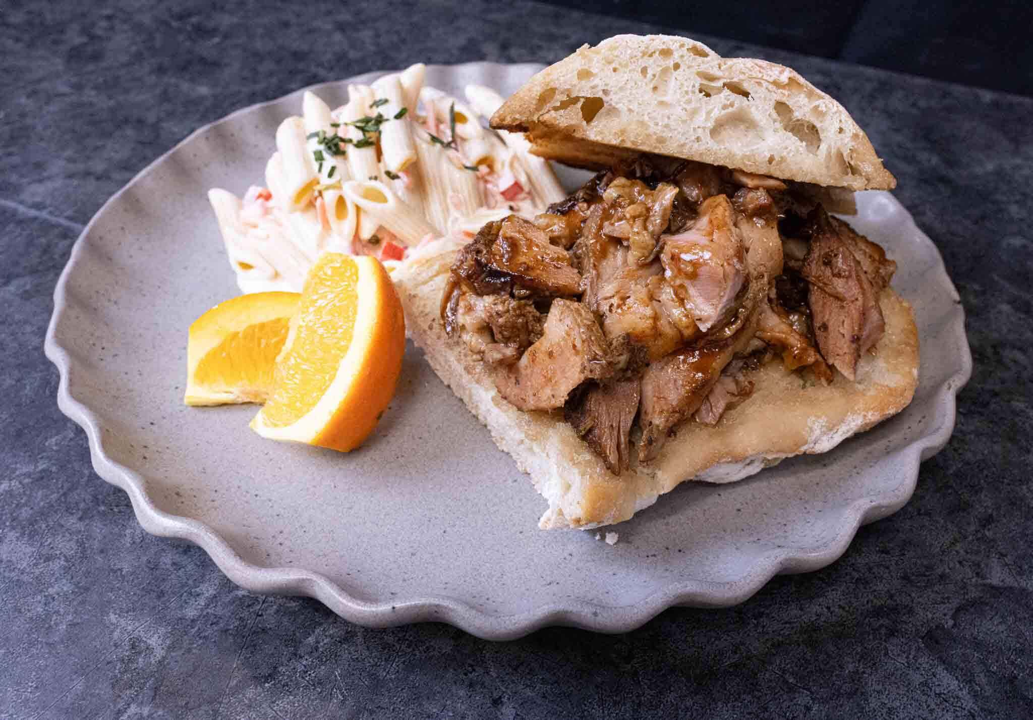 BBQ pulled pork sandwich on ciabatta bread, with penne pasta coleslaw