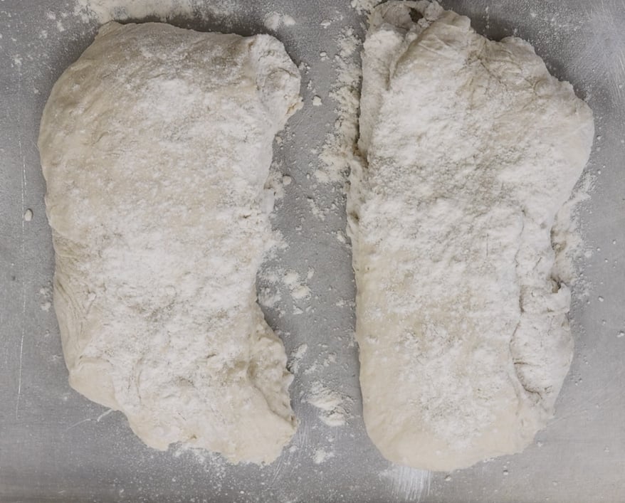 pounding the dough into the baguette shape