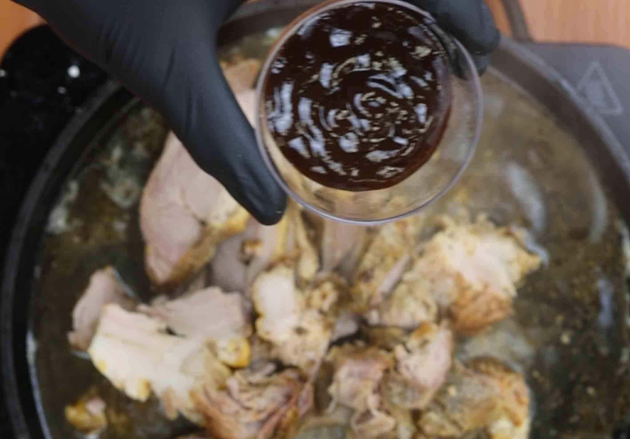 chef adds barbecue sauce to the pan